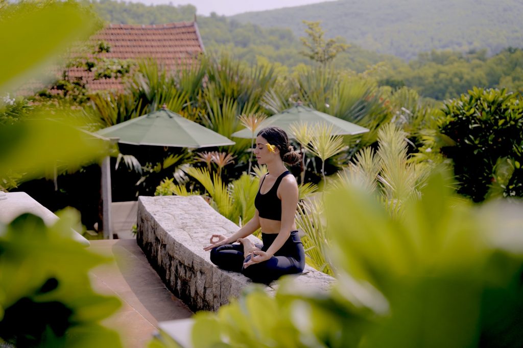 woman meditating at resort in nature